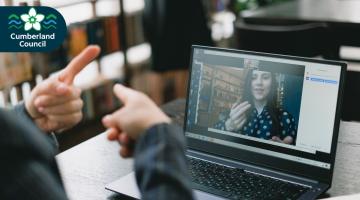 graphic showing a person using sign language during a video call on a laptop